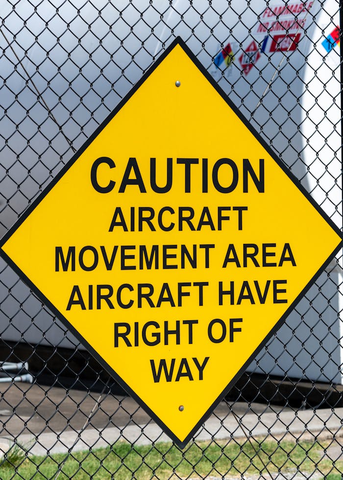 a-sign-that-says-caution-aircraft-movement-area-has-right-of-way-27773161 a-sign-that-says-caution-aircraft-movement-area-has-right-of-way-27773161
